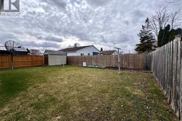 Backyard with shed, satellite dish, fence, clothesline & pool - 68 Greenbriar Trail Wallaceburg