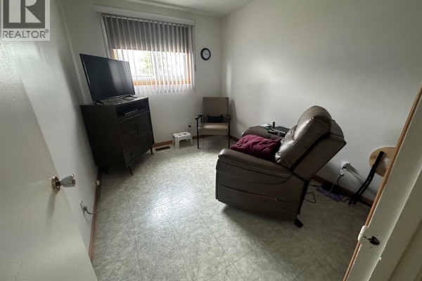 Recliner, dresser, and TV in a living room - 68 Greenbriar Trail Wallaceburg
