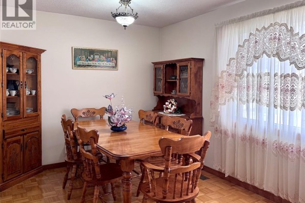 Wooden dining table, chairs, hutch, and curio cabinet with ornate curtains - 68 Greenbriar Trail Wallaceburg