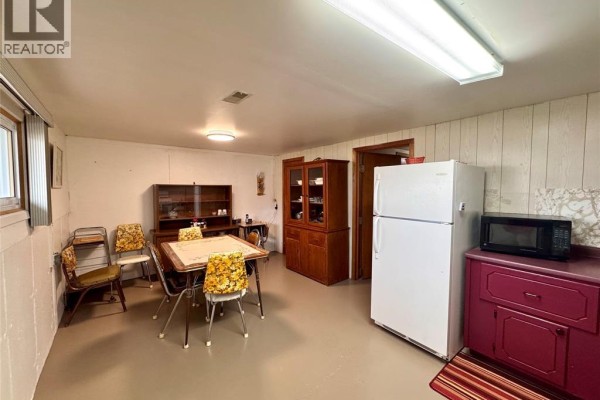 Kitchen with dining table, hutch, refrigerator, and microwave - 68 Greenbriar Trail Wallaceburg