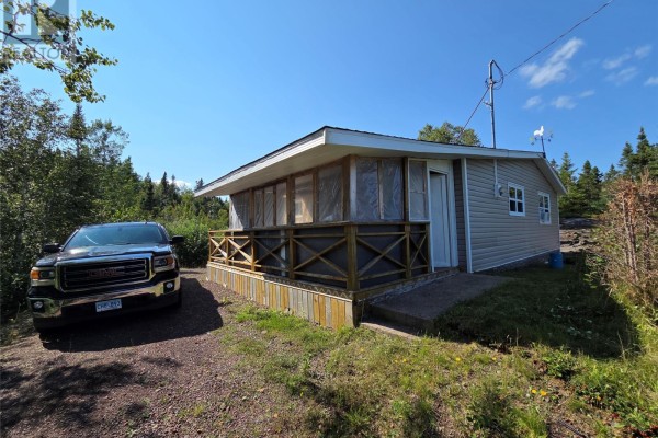Front three-quarter view of the cottage with a pickup truck parked to the left. - 68 Main Street, Charles Brook