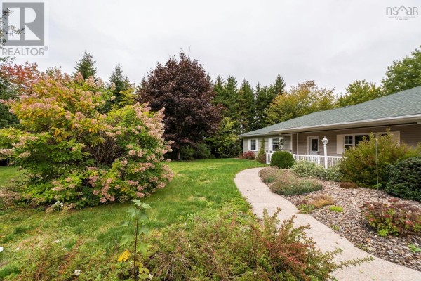 View of the side of the house with trees and shrubs in the foreground. - 68 Two Rivers Drive, Mineville
