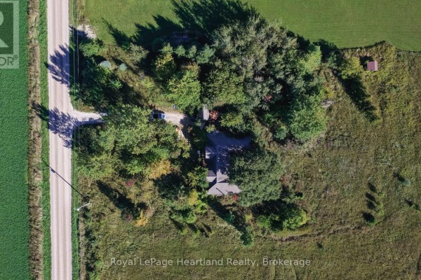 Overhead aerial view of the secluded house, surrounded by mature trees and bordering a rural road and fields. - 68 Victoria Street, Ashfield Colborne Wawanosh