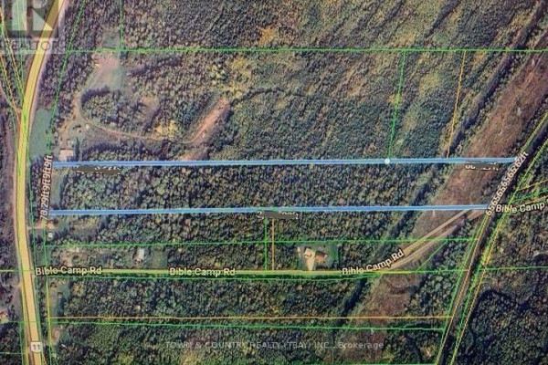 An aerial view showing property lines and lot boundaries within a wooded area. - 680 Hwy 11/17, Dorion