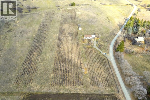 Panoramic view of rolling hills and a winding road through the landscape. - 6805 Reservoir Road, Grand Forks