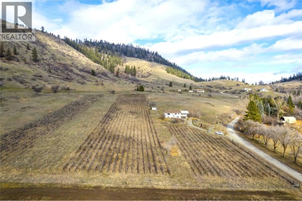 Aerial shot showing agricultural land with a house and road on the edge. - 6805 Reservoir Road, Grand Forks