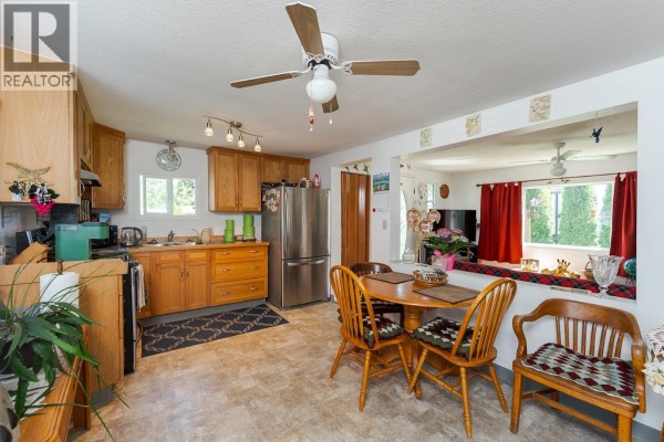 Entrance area with a white door, coat rack, and shoe rack. - 6815 Langer Crescent, Prince George