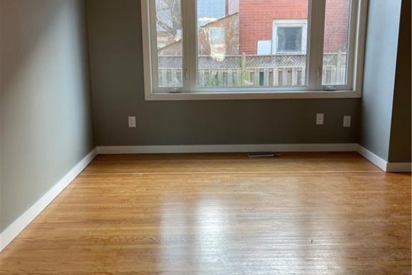 Room with a bay window, wooden floors, and grey walls. - 683 Coronation Boulevard Unit# 2, Cambridge