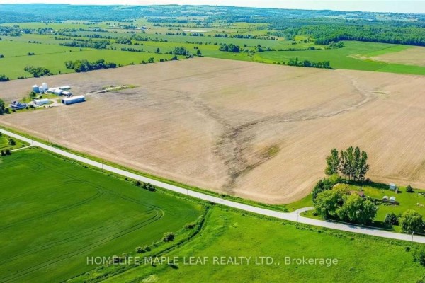 Aerial view of farm buildings and agricultural fields in Clearview. - 6830 3/4 Side Road, Clearview