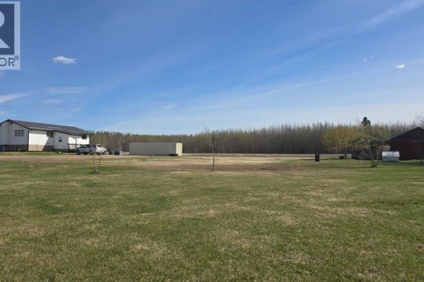 Open kitchen featuring wooden cabinets, black appliances, and a central island with white countertops. - 683010 Rg Rd 175, Atmore