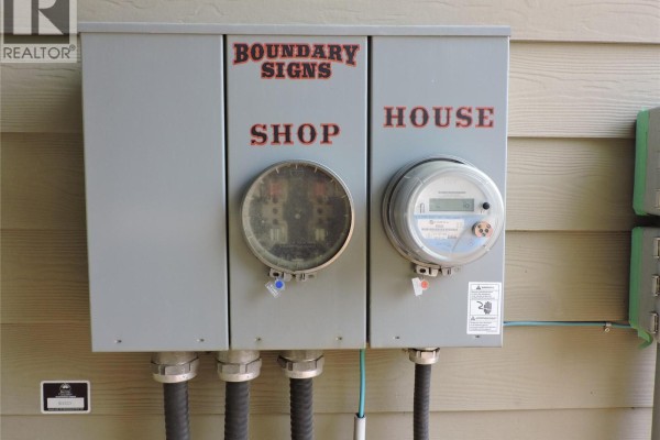 Utility meter panel labeled for shop and house, with multiple connections. - 684 Government Avenue N, Greenwood