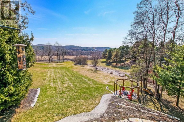 Panoramic view of rolling hills and trees from the property's elevated backyard. - 684744 Highway No 2 Highway, East Zorra Tavistock