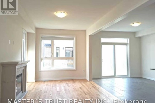 Interior view showing the living room with a fireplace and view to the sliding patio doors. - 69 Mallery Street, Richmond Hill