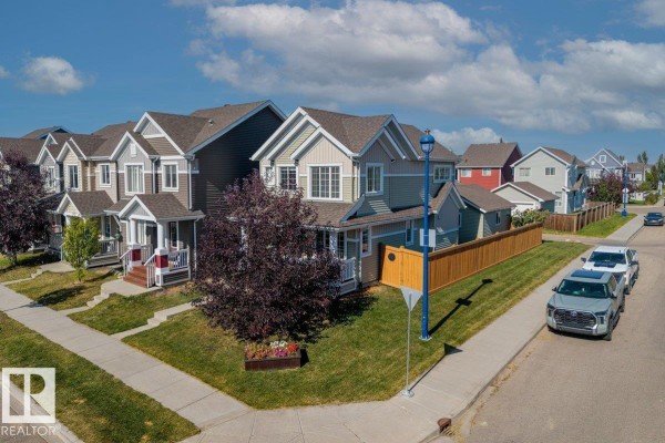 Aerial view of a suburban street with several houses, including the property at 6906 23 Av Sw. - 6906 23 Av Sw, Edmonton