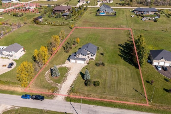 Aerial view of the residential property showing lot boundaries and surrounding homes. - 691 Toshack Road, West St Paul