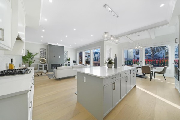 Entrance hall with a white front door and a staircase with wooden treads and black spindles. - 6923 205 Street, Langley