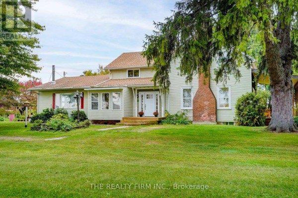Exterior of a light green house with a large brick chimney and manicured lawn. - 695 Cameron Road, Dawn Euphemia