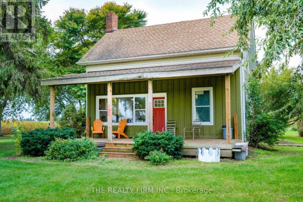 Close-up of the front porch with Adirondack chairs and red front door. - 695 Cameron Road, Dawn Euphemia