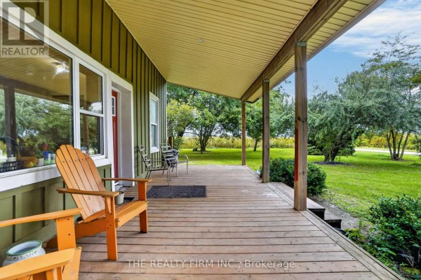 Wooden porch with seating and view of the tree-lined property. - 695 Cameron Road, Dawn Euphemia