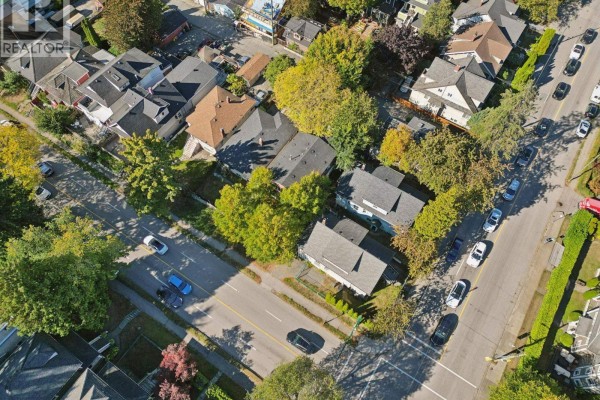 Aerial view of residential houses and streets with mature trees and parked cars. - 695 E 12th Avenue, Vancouver