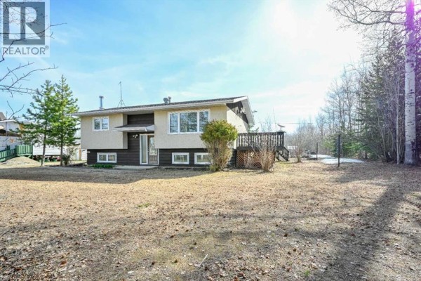 Exterior view of a residential home surrounded by snow and trees - 69565 Range Road 65, Grovedale