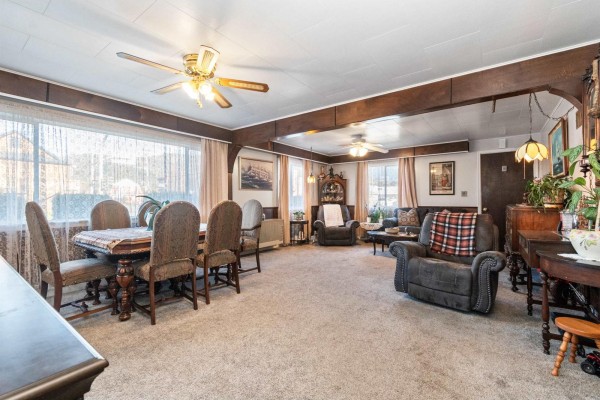 Combined living and dining area with a dining table, ceiling fans, and decorative furnishings. - 6994 Cheam Avenue, Agassiz, Agassiz