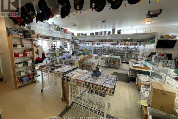 Interior view of a retail store with shelves stocked with video games and merchandise. - 7 - 157 Bayfield Street, Barrie