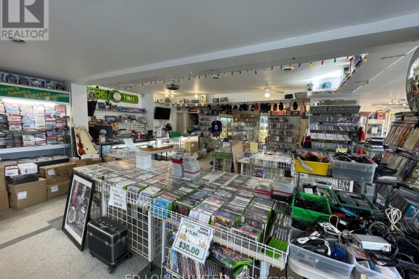 Wide interior shot of a retail store displaying video games, consoles, and accessories. - 7 - 157 Bayfield Street, Barrie