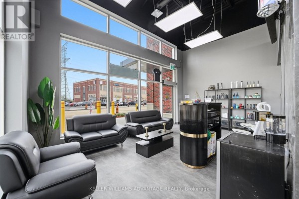 Interior view of a commercial space with large windows offering a view of the street and adjacent buildings. - 7 - 41 James Snow Pkwy N Parkway, Milton