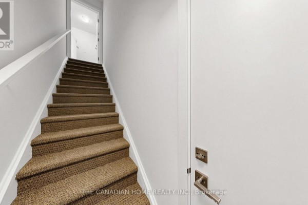 Interior staircase with light brown carpet and white walls leading upwards. - 7 - 45 Romilly Avenue, Brampton