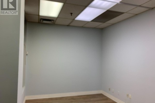Empty commercial office space with light blue walls and drop ceiling. - #7 - 60 Amber Street, Markham