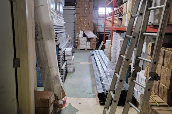 Warehouse interior with stacked boxes, shelving, and a ladder leaning against the shelves. - #7 - 60 Amber Street, Markham