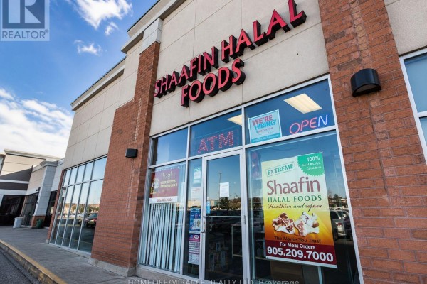 Storefronts for "Shaafin Halal Foods" and other businesses on Markham Road. - 7 - 7595 Markham Road, Markham