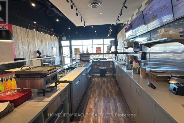 Dining area in barBurrito with booth seating and pendant lighting - 7 - 900 Watters Road, Ottawa