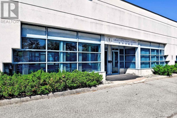 Close-up exterior view of the commercial building entrance with signage for Grace Liang Liang Church. - 7 & 8 - 95 Royal Crest Court, Markham