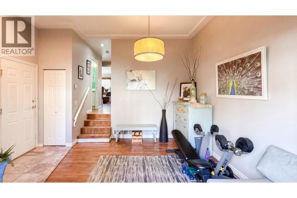 Cozy corner of the living area featuring a sliding door to the patio and decorative elements. - 7 21409 Ne Dewdney Trunk Road, Maple Ridge