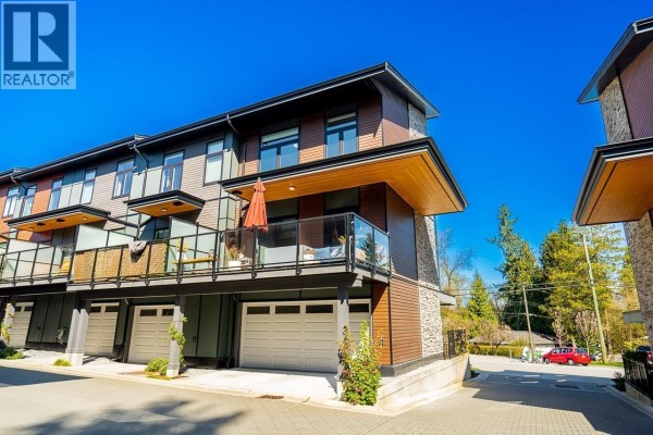 Townhouse exterior with garages and balconies, overlooking a street with trees. - 7 50 Seaview Drive, Port Moody