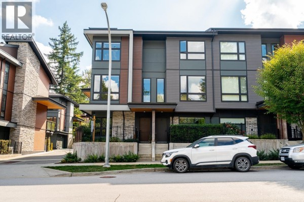 Front exterior of a three-story townhouse with stone and wood siding. - 7 50 Seaview Drive, Port Moody