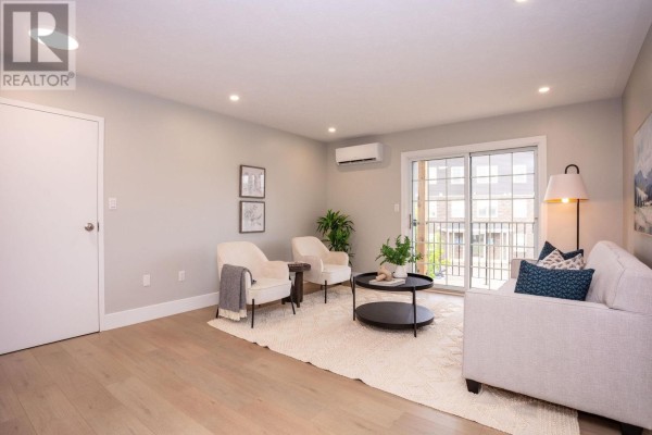 Living room seating area with two chairs, a sofa, and a sliding glass door. - #7 8 Glen Stewart Drive, Stratford
