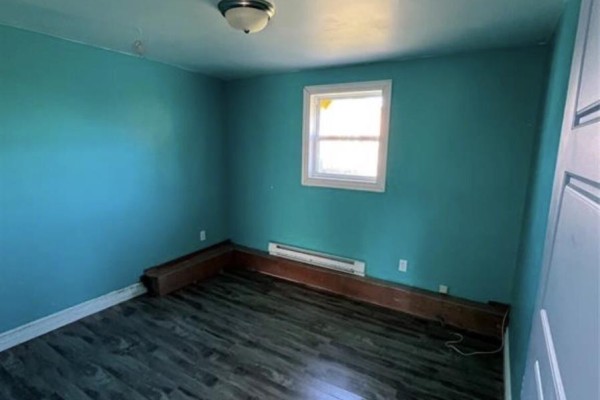 Small room with turquoise walls, a window, and a wooden shelf mounted high on the wall. - 7-9 Holmes Road, Shearstown