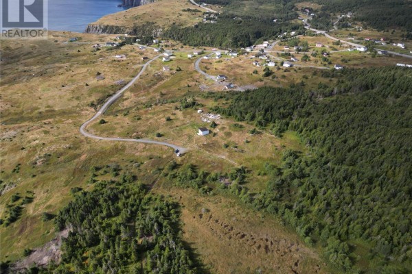 Drone shot showing multiple houses in a small community, with a forested area and a lone house on a hill. - 7 Amys Hole Road, Jobs Cove