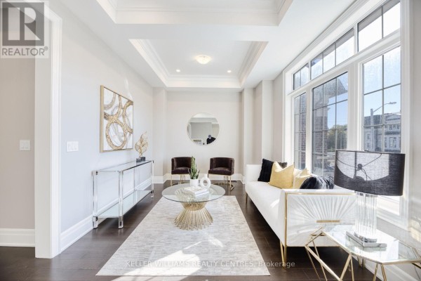 Living room with a large window, sofa, glass coffee table, and modern console table. - 7 Becky Cheung Court, Toronto