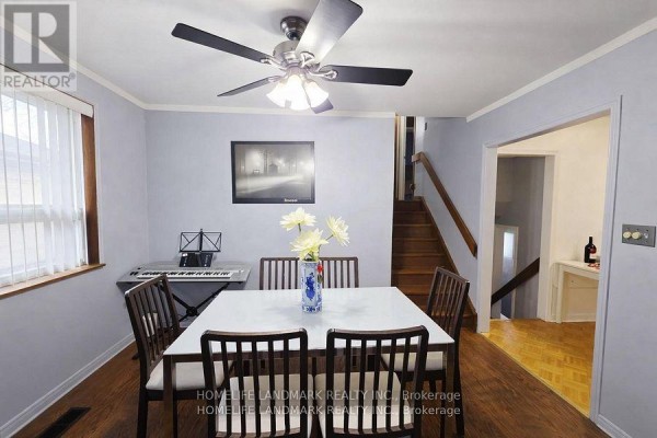 Living room with seating area, dining space, and staircase - 7 Burtonwood Crescent, Toronto