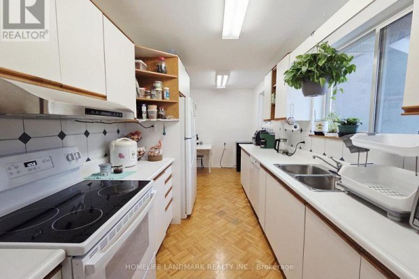 Dining area with table, chairs, and ceiling fan, adjacent to living room - 7 Burtonwood Crescent, Toronto