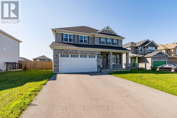 Side view of the two-story house with a driveway, lawn, and neighboring houses. - 7 Cottonwood Drive, Belleville