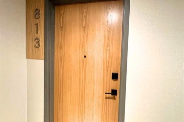 Close-up of a light wood apartment door with a modern handle and the unit number 813. - 7 Erie Avenue Unit# 813, Brantford