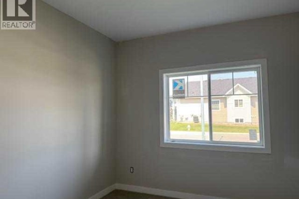 View into living room with large windows and unfinished flooring - 7 Gray Close, Sylvan Lake