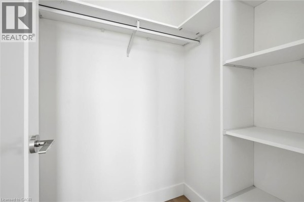 Room with three doors, showing access to a bathroom and the main living area. - 7 Mabelle Avenue Unit# Ph07, Toronto