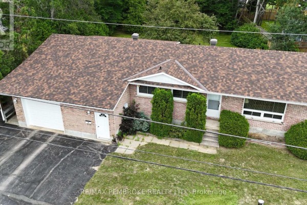 Aerial view of the bungalow's roof, brick exterior, attached garage, and front yard. - 7 Martin Street, Laurentian Hills