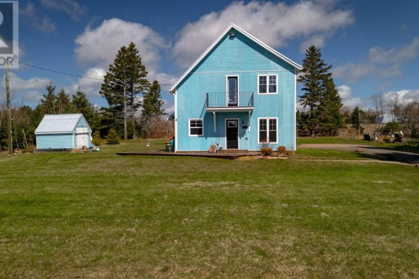 Front view of a bright blue two-story house with a small balcony and a white-trimmed roof. - 7 Mckenna Drive, Brudenell